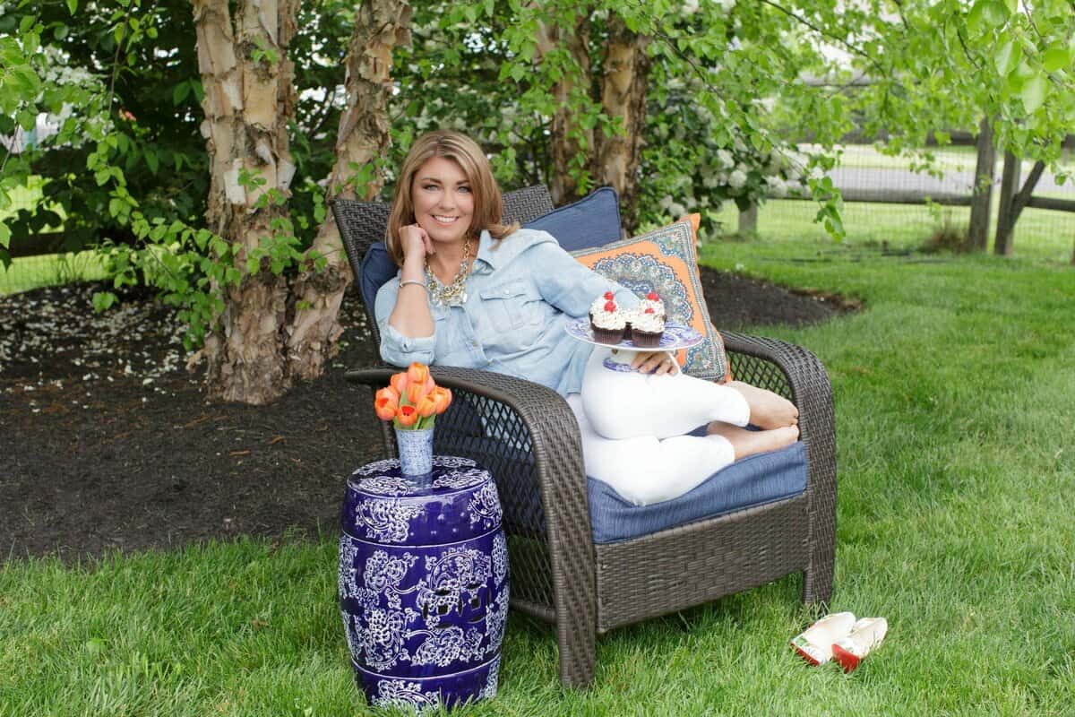 Kellie Hemmerly sitting in an armchair in a garden.