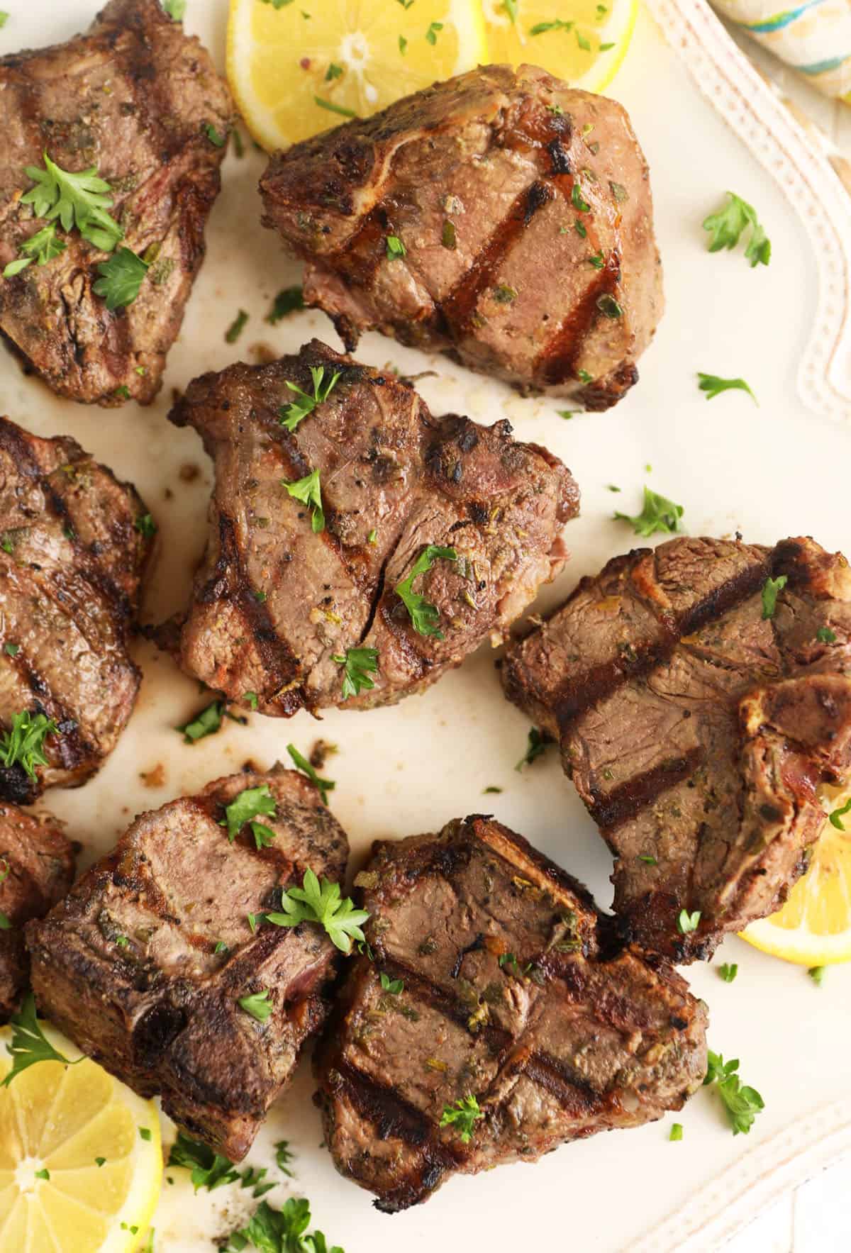 Overhead view of grilled lamb loin chops on platter