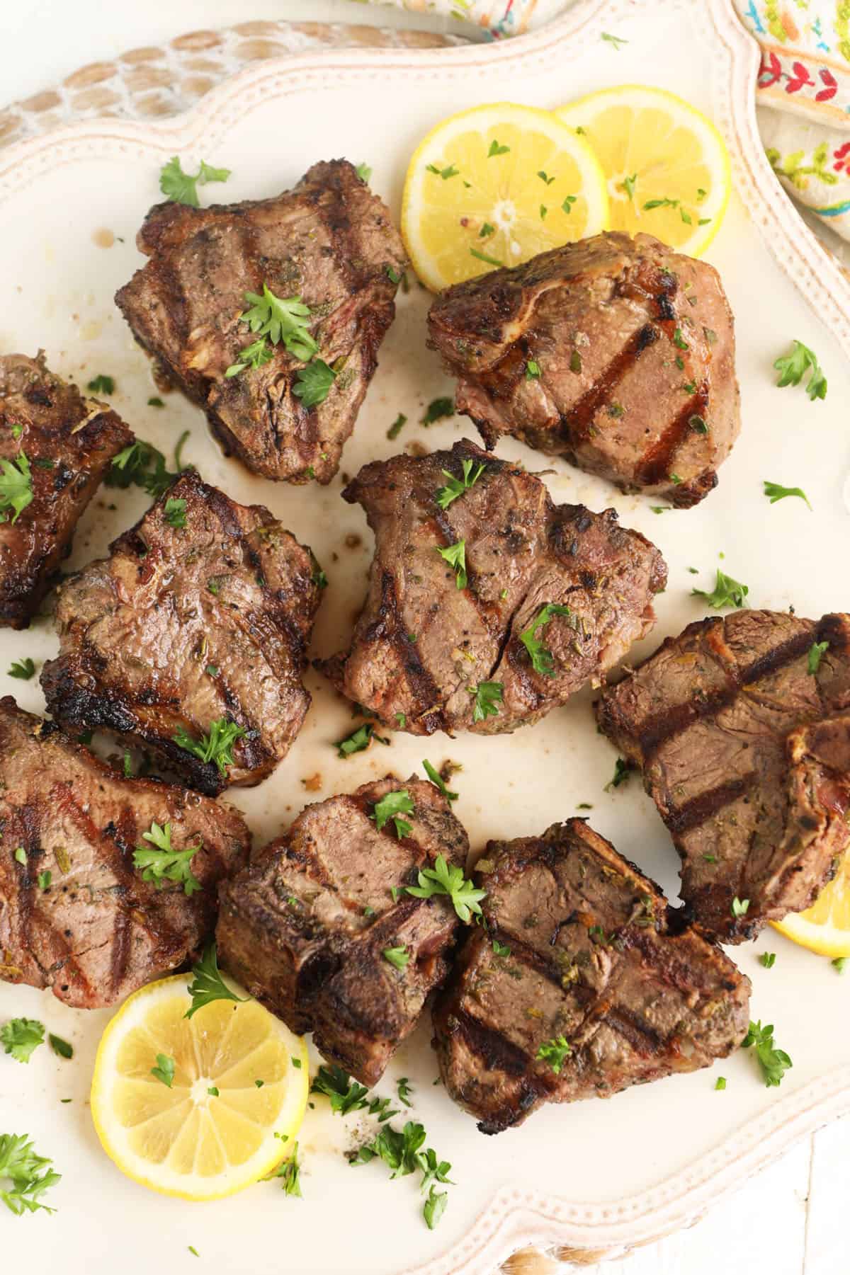 Overhead view of grilled lamb loin chops on platter