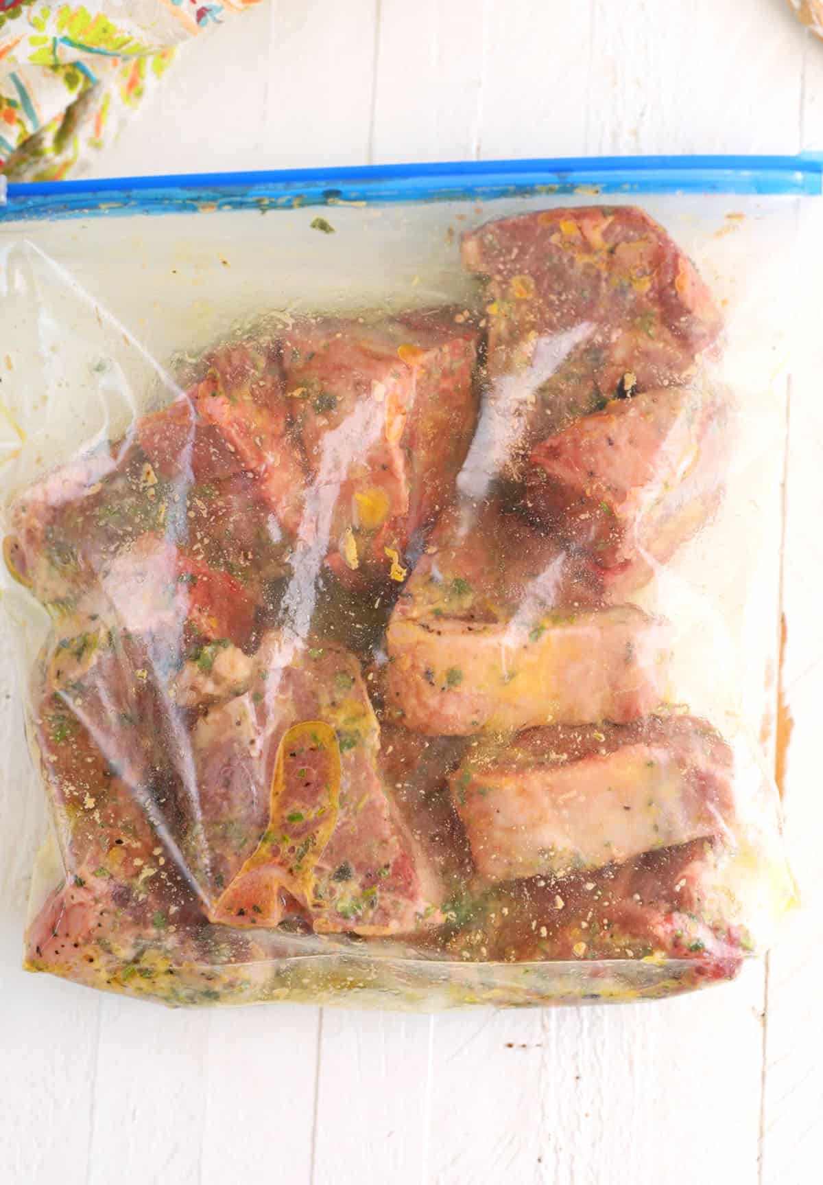 Lamb loin chops marinating in zip-top bag