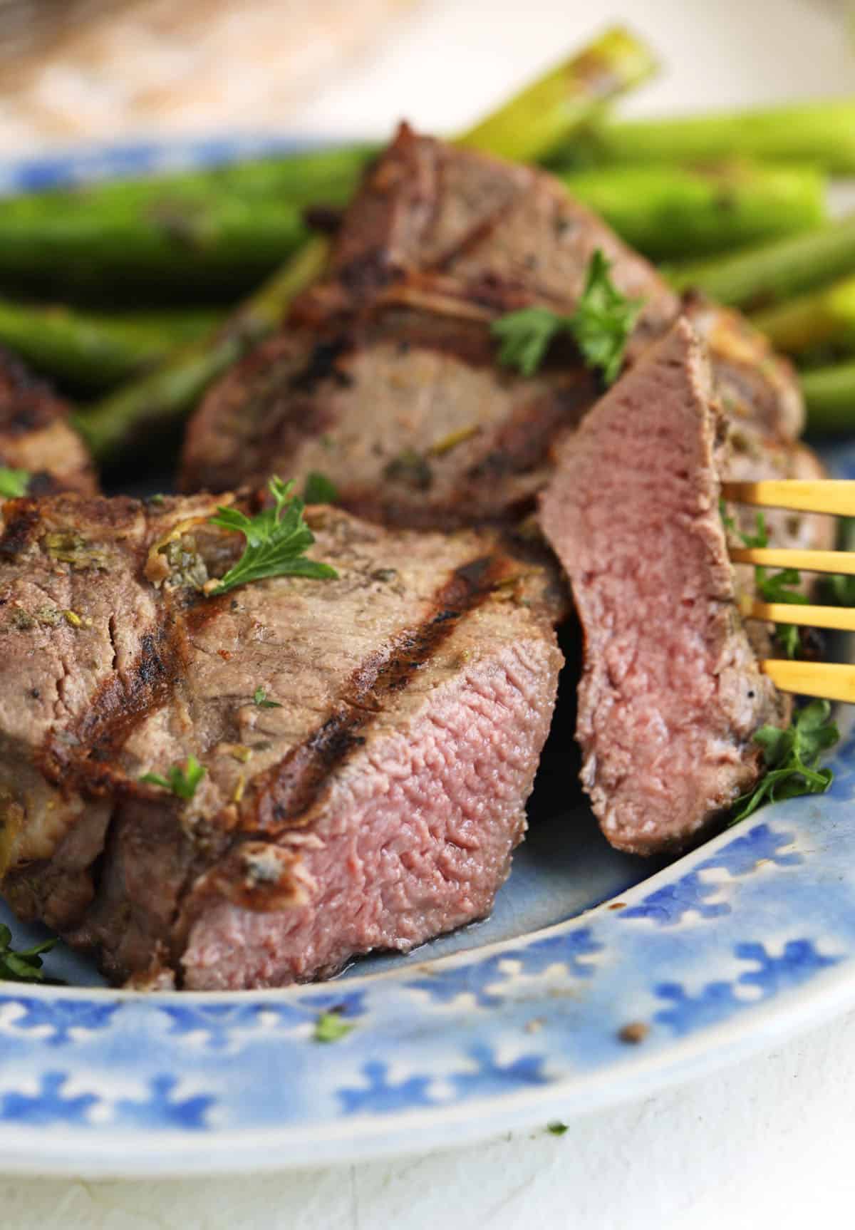 Sliced grilled lamb loin chops on plate