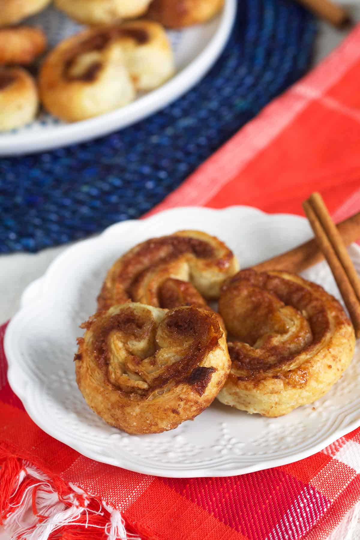 Three palmiers are placed on a small white plate.