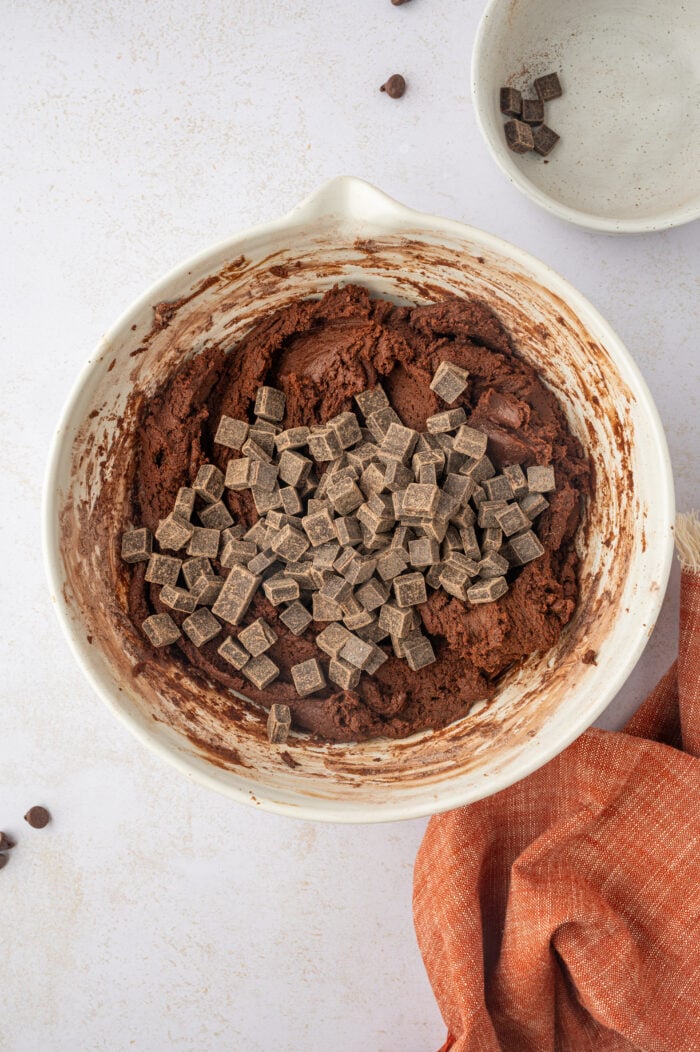 Chocolate chunks added to bowl of cookie dough