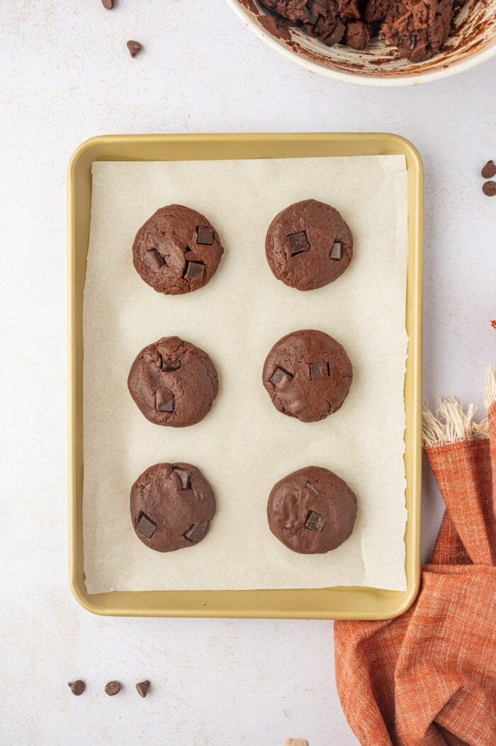 Overhead view of flattened dough for double chocolate chip cookies