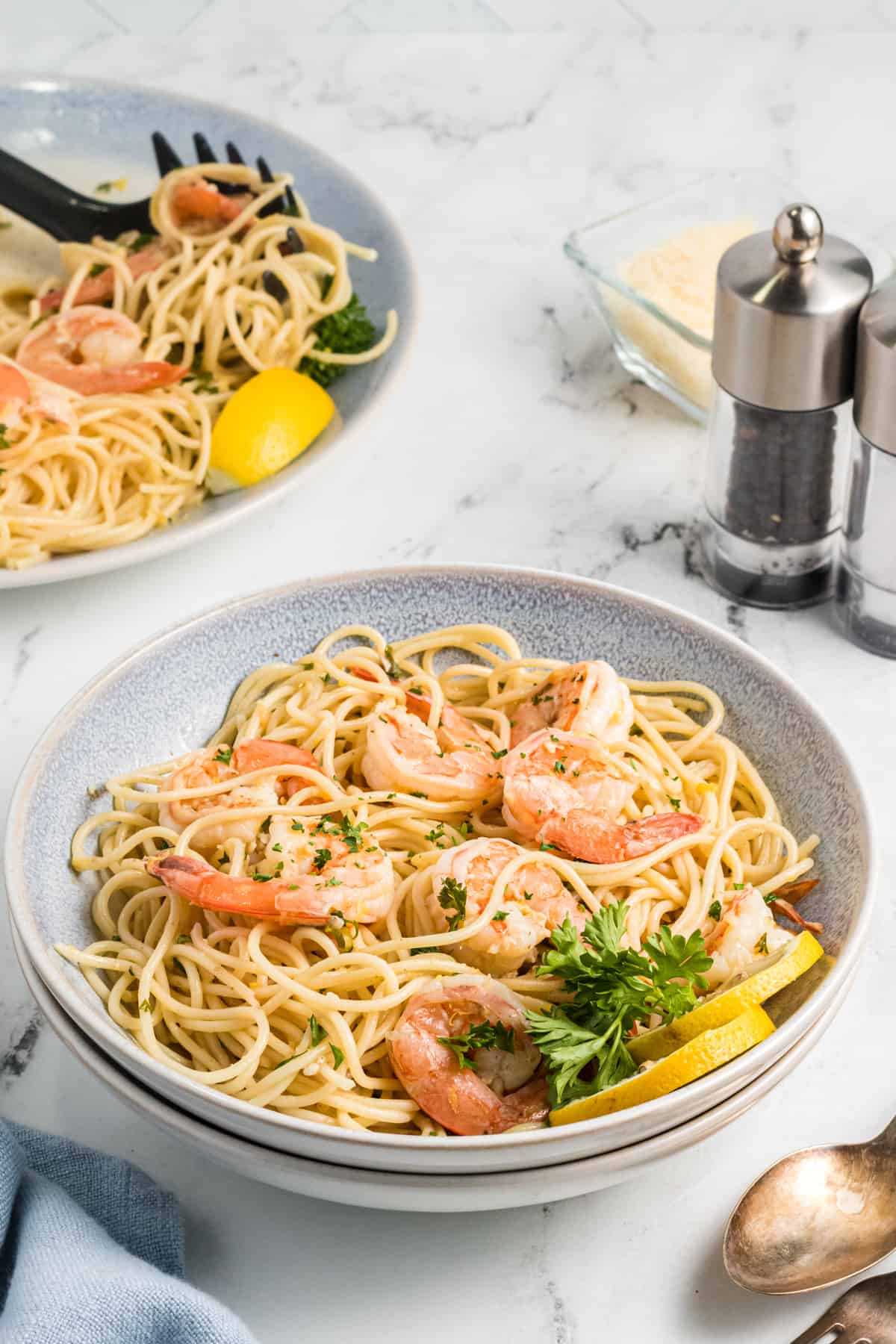 A stack of bowls are filled with shrimp scampi.