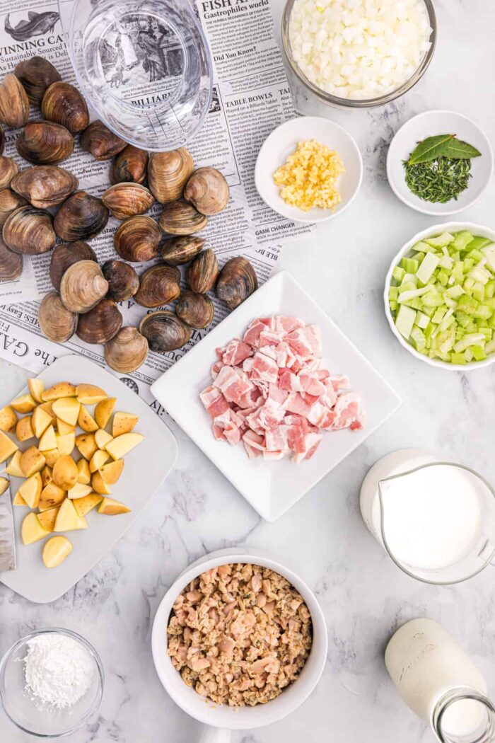 The ingredients for New England Clam Chowder are presented on a countertop. 