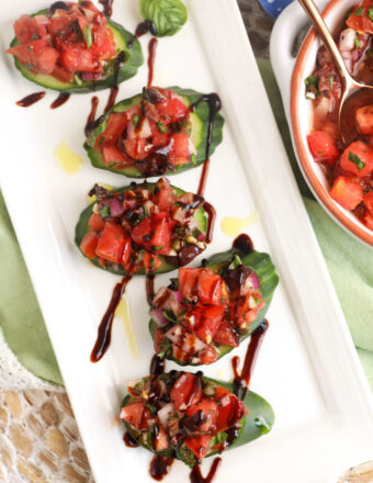 Platter with cucumber bruschetta drizzled with balsamic vinegar