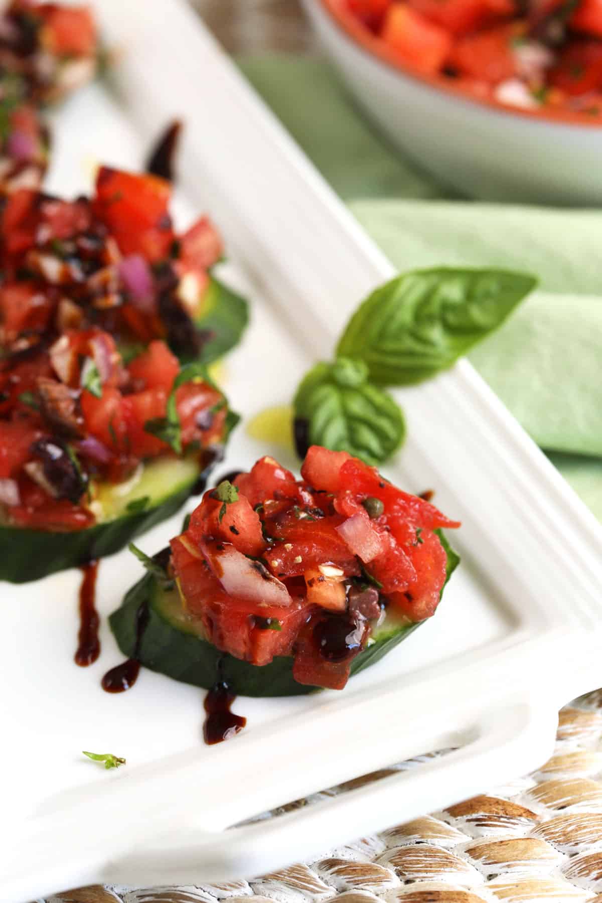 Cucumber bruschetta slices on platter