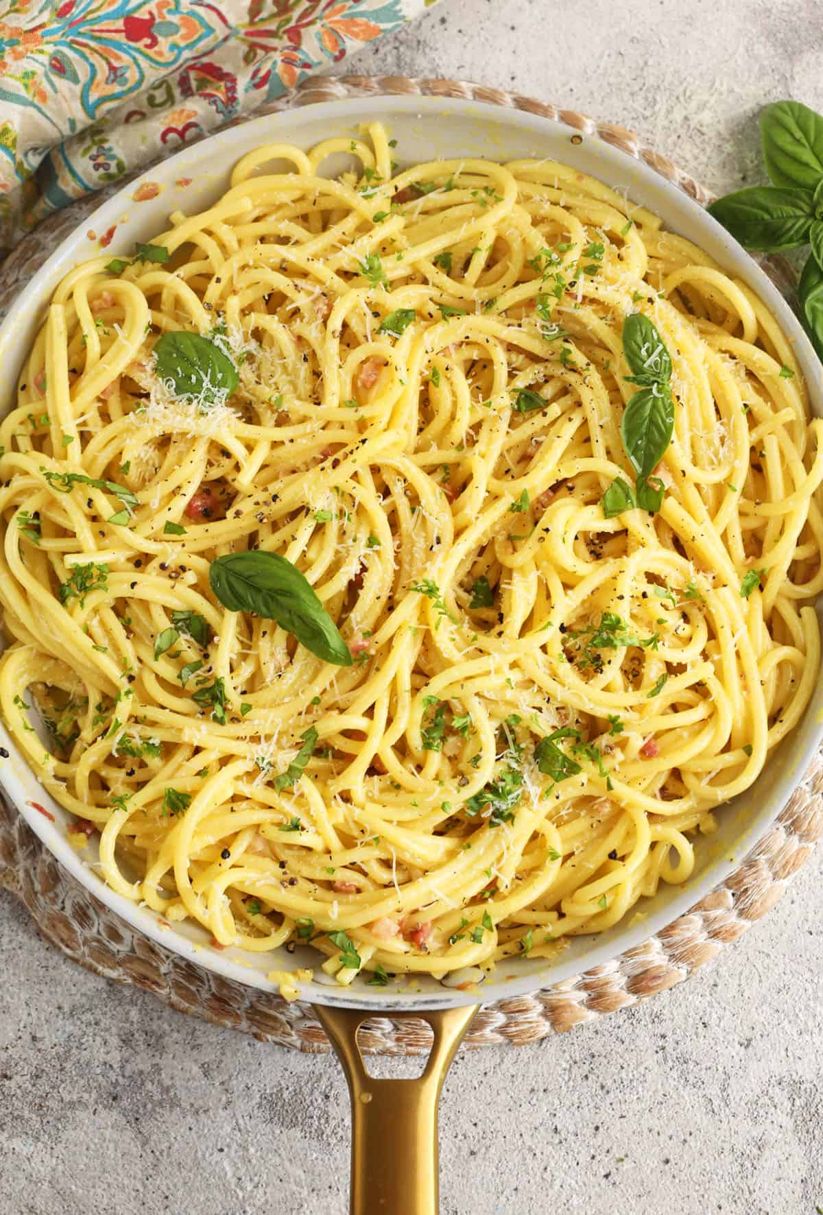 Overhead view of pasta carbonara in skillet