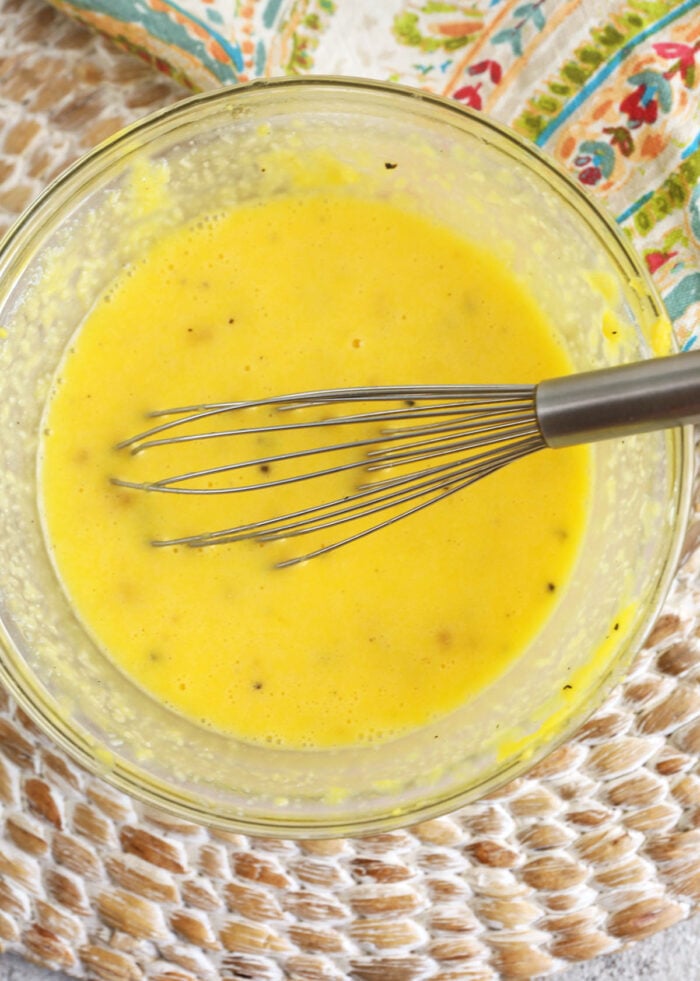 Overhead view of whisking ingredients for pasta carbonara sauce