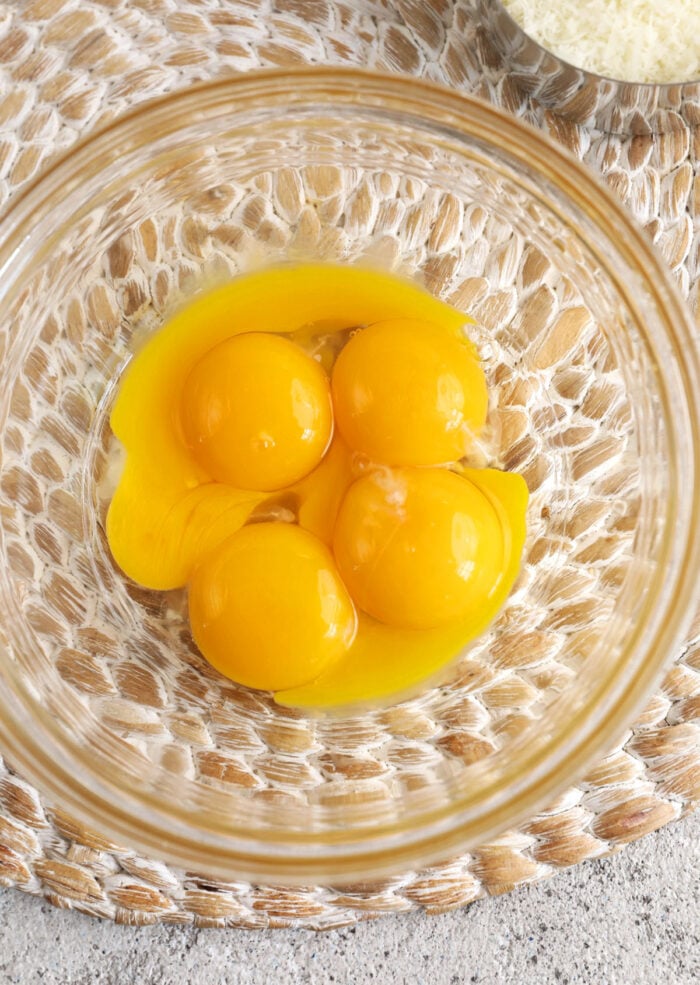 Overhead view of egg yolks in mixing bowl