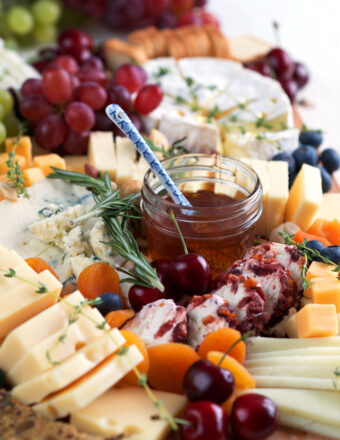 Cheese board with cheese, fruit, honey, etc.