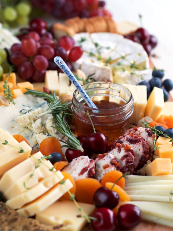 Cheese board with cheese, fruit, honey, etc.