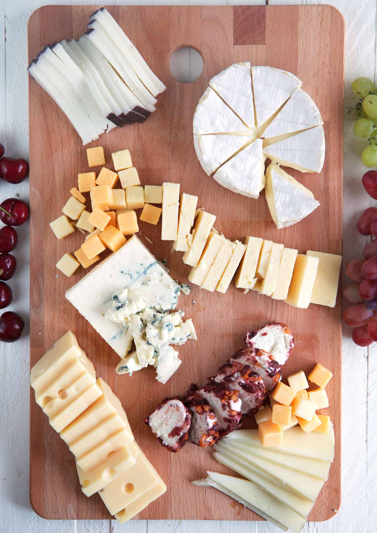 Layering cheese onto cheese board