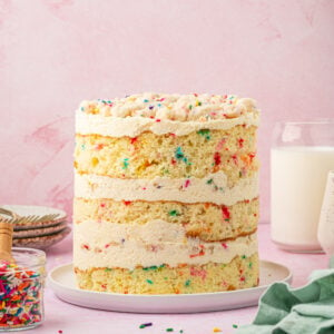 Side view of whole Milk Bar birthday cake on cake plate