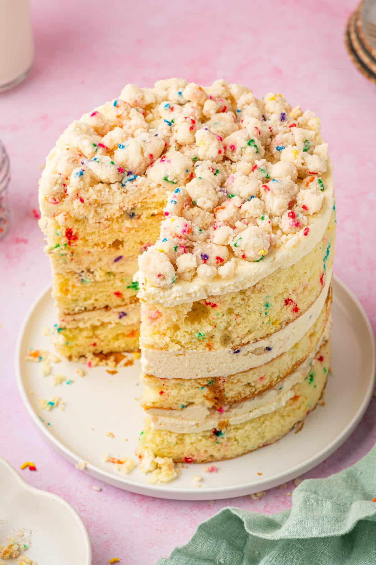 Milk Bar birthday cake on plate with slices removed