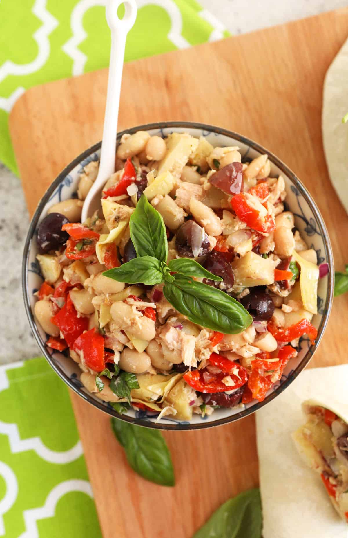 Overhead view of Mediterranean tuna salad in bowl with spoon