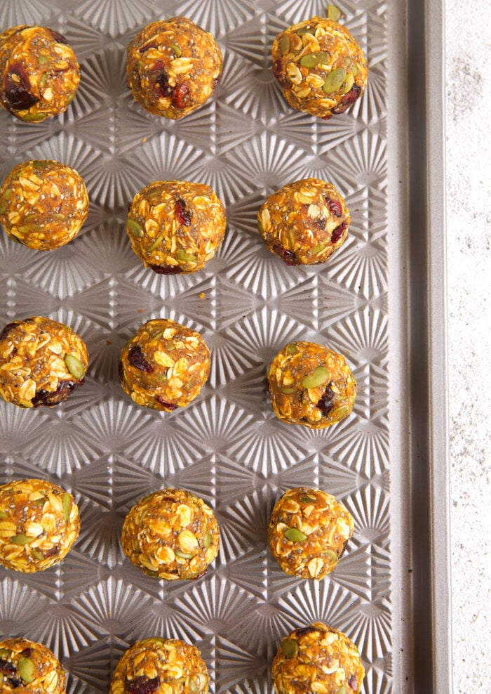 Overhead view of pumpkin energy bites on sheet pan