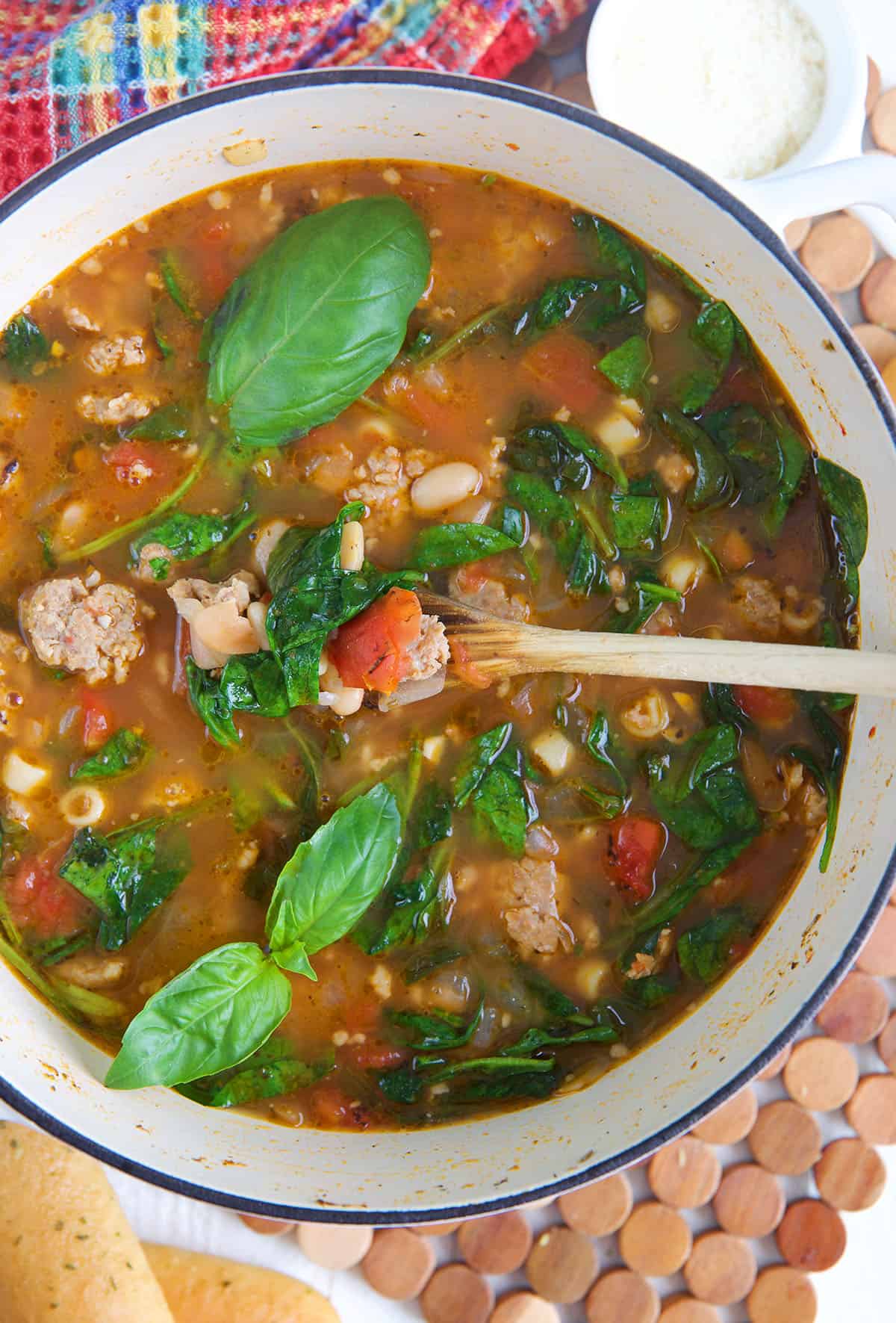 Overhead view of Italian sausage soup in Dutch oven