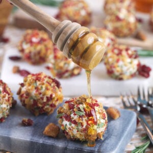 Drizzling honey onto goat cheese balls