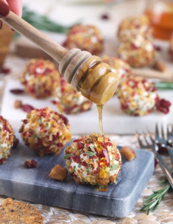 Drizzling honey onto goat cheese balls