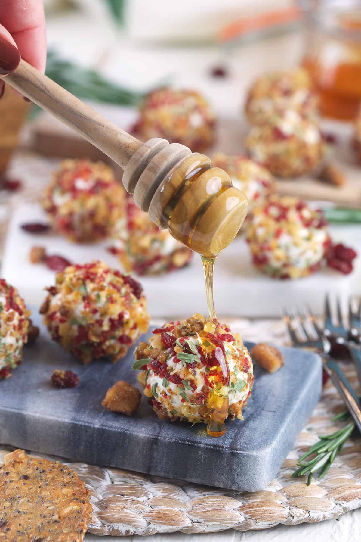 Drizzling honey onto goat cheese balls