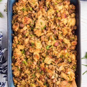 A large baking dish is filled with chestnut sausage stuffing.