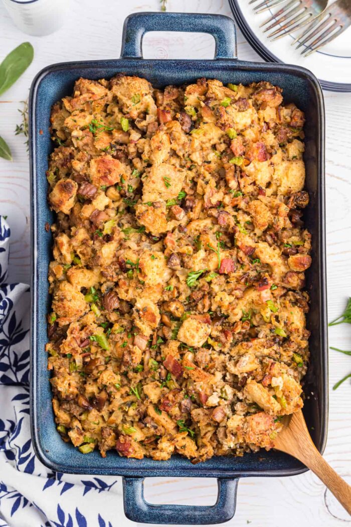 A large baking dish is filled with chestnut sausage stuffing. 