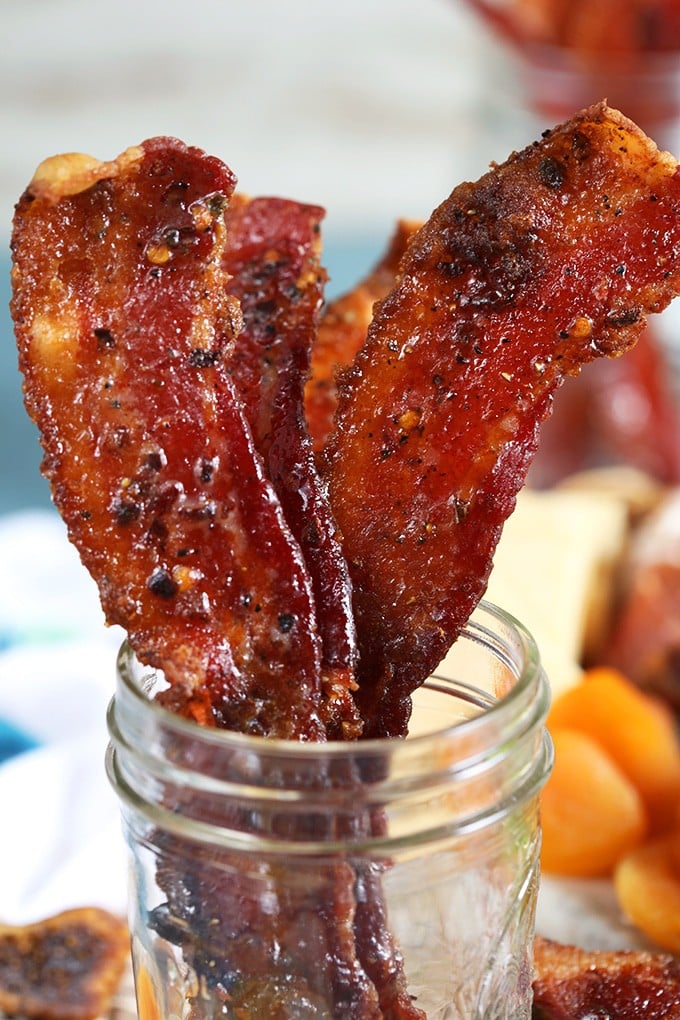 Close up of sweet and spicy candied bacon in a mason jar.