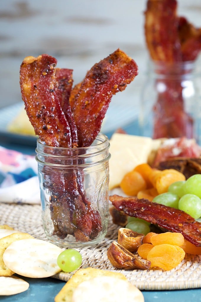 Sweet and Spicy candied bacon in a mason jar with charcuterie tray.