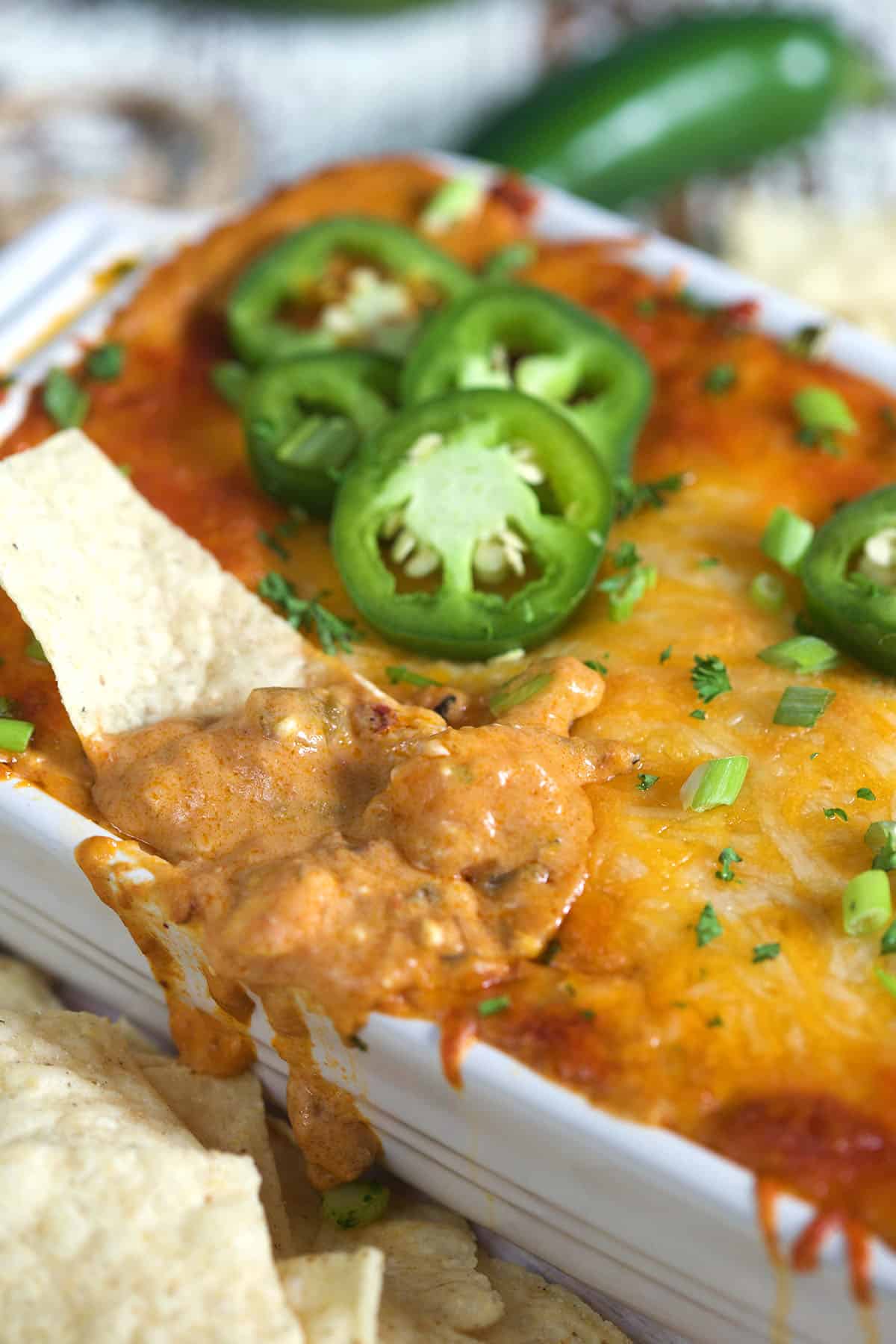 Chili cheese dip with a chip in it.