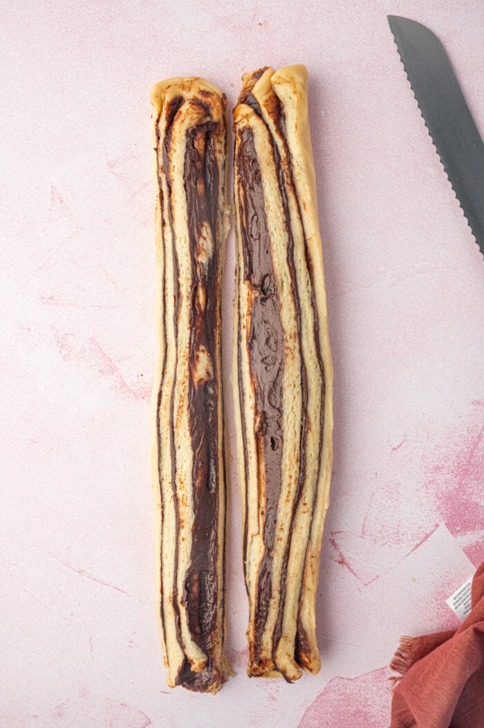 Overhead view of two slit chocolate babka dough logs