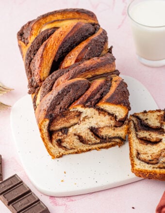 Top-down view of chocolate babka with slice cut to show swirls inside