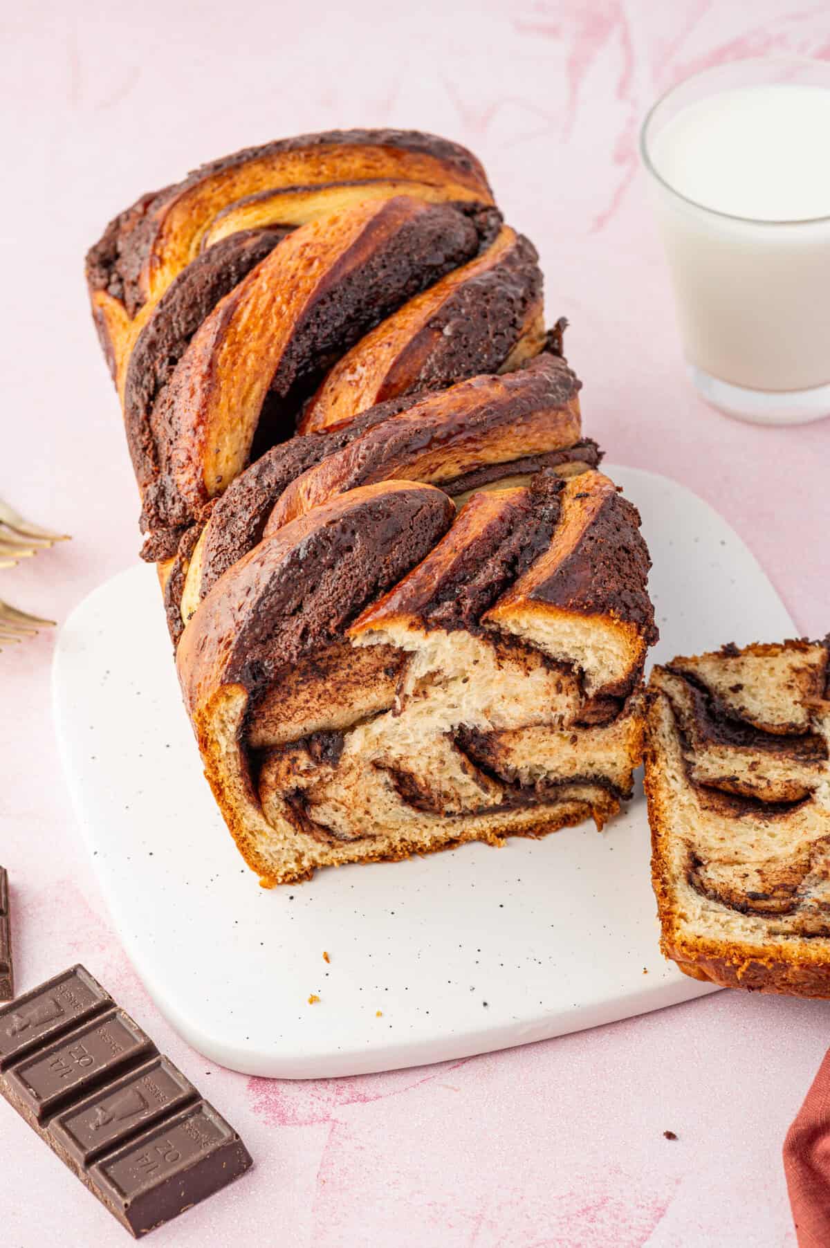 Top-down view of chocolate babka with slice cut to show swirls inside