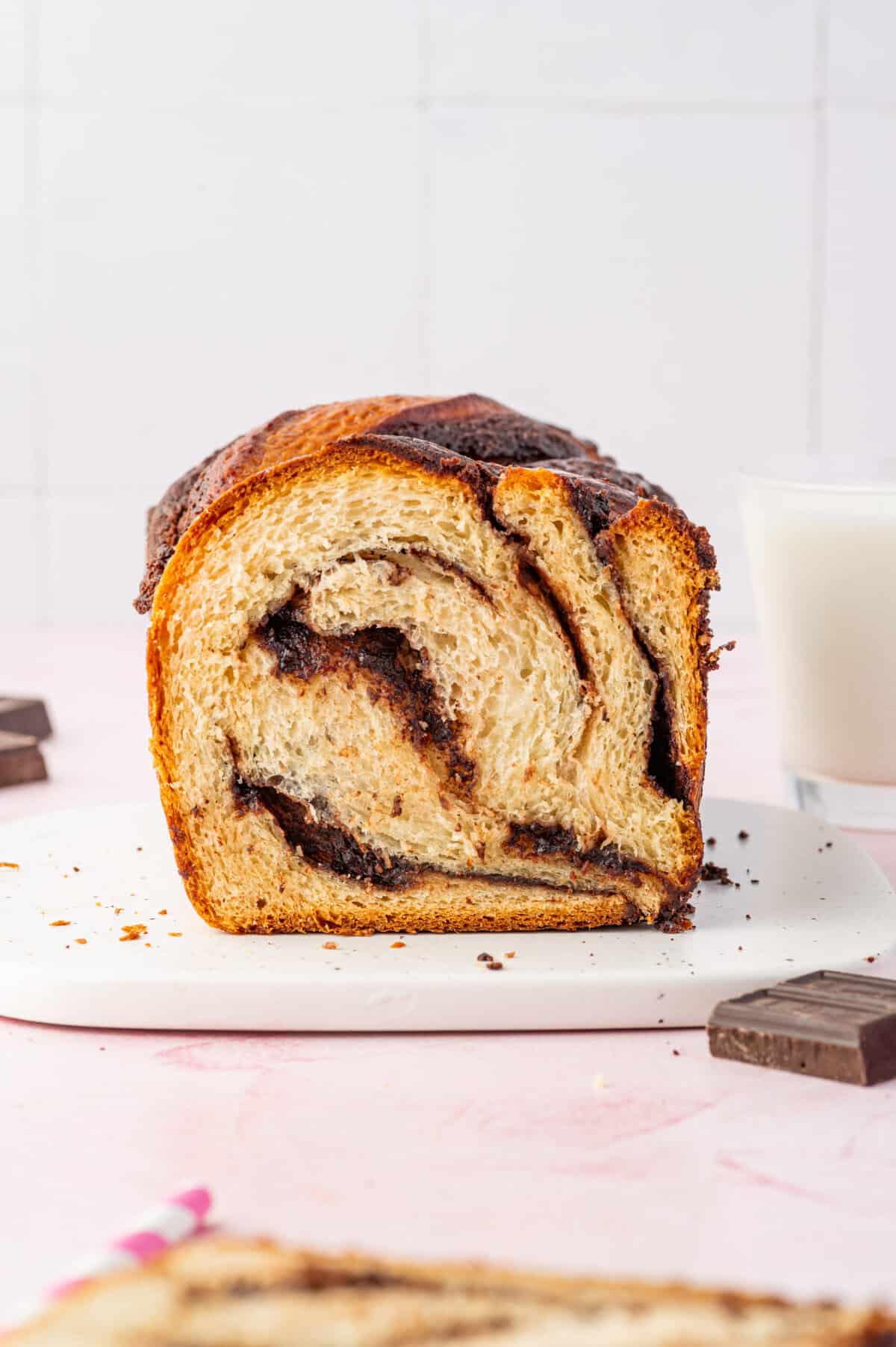 Sliced chocolate babka standing on cutting board