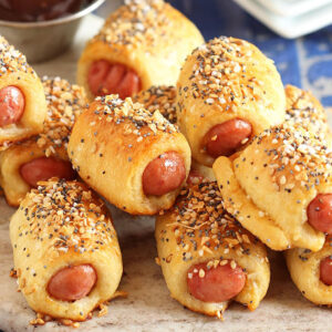 Pile of pigs in a blanket on a marble board.