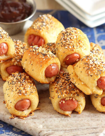 Pile of pigs in a blanket on a marble board.