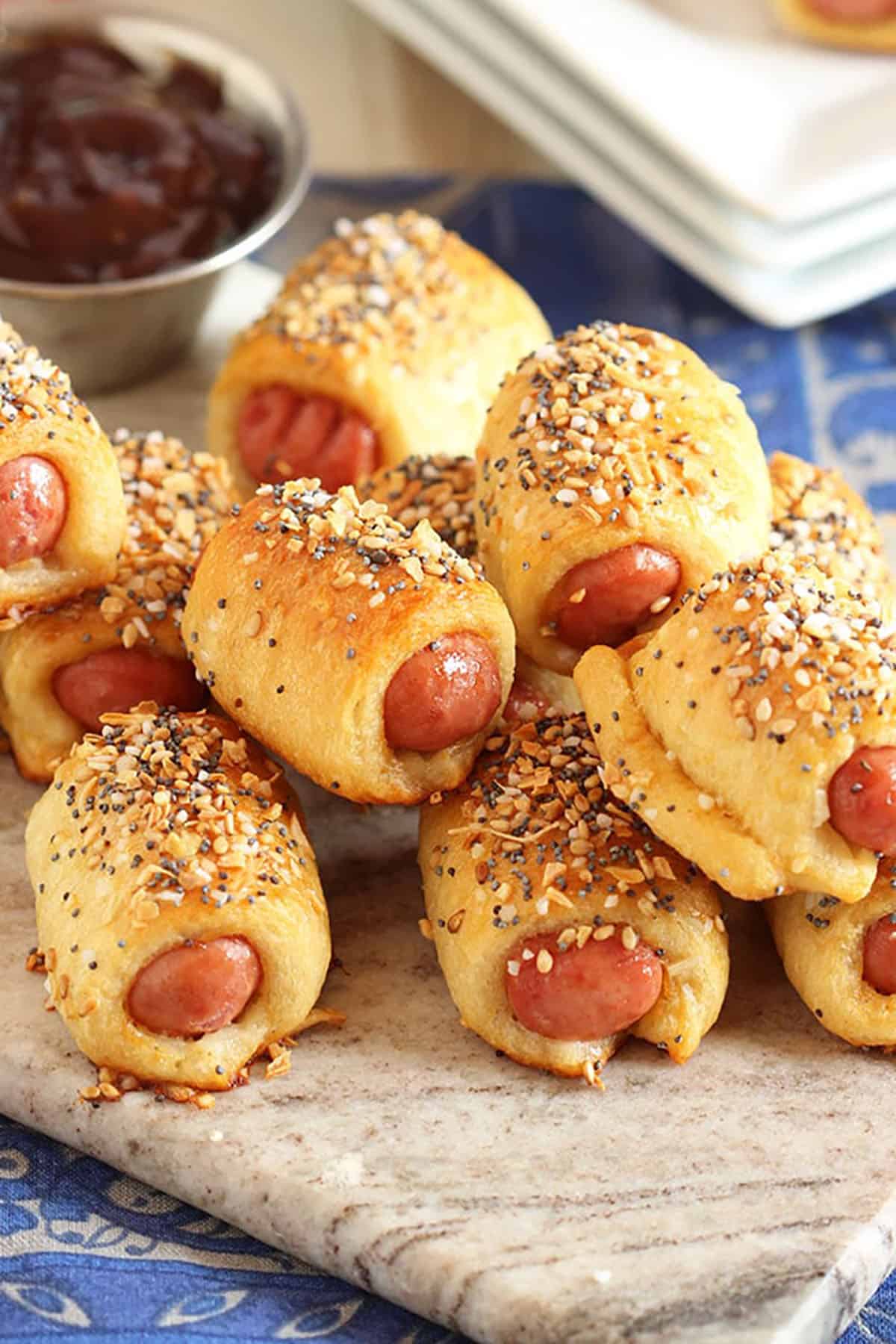 Pile of pigs in a blanket on a marble board.