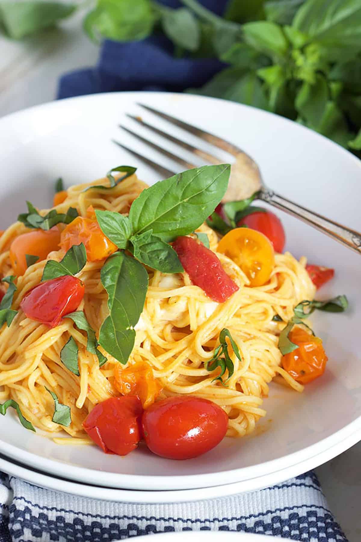 Caprese Pasta in a white bowl with a vintage fork.
