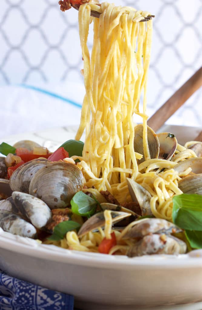 This easy Linguine with Clams Chorizo and Roasted Tomatoes is loaded with flavor and is ready in about 30 minutes. From TheSuburbanSoapbox.com