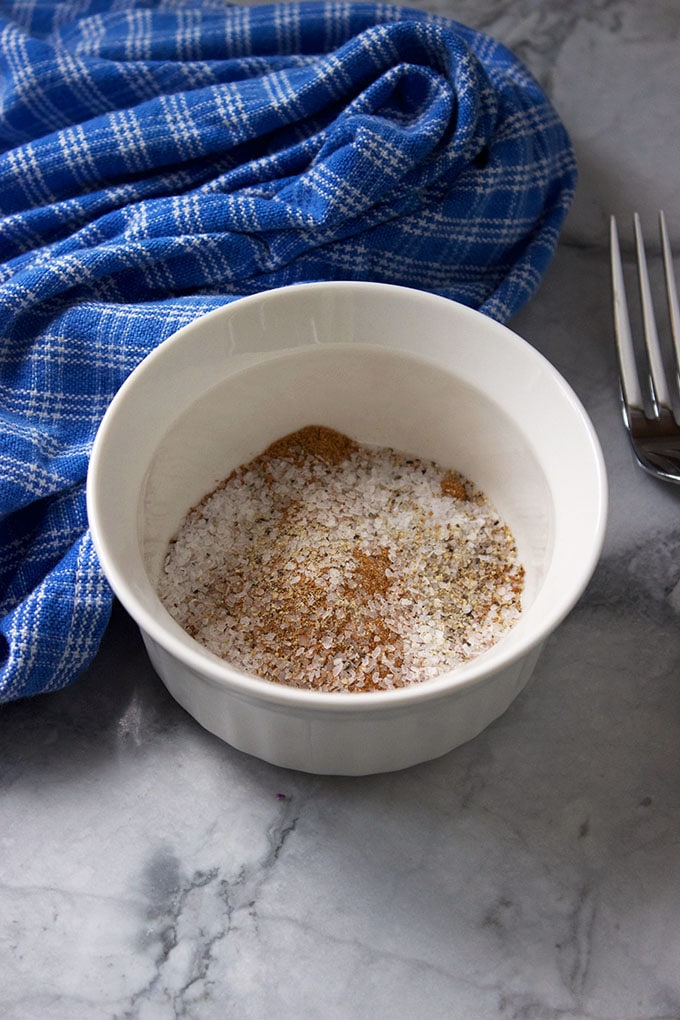 Five Spice Rub for flank steak in a white bowl on a marble background.