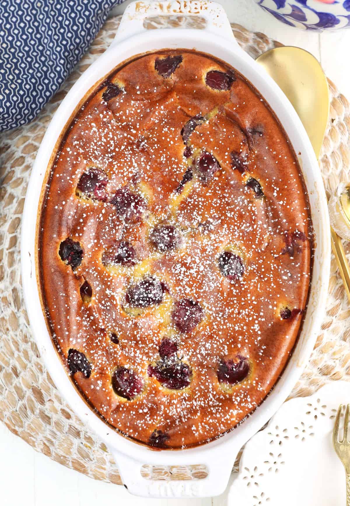 Overhead view of cherry clafoutis dusted with powdered sugar