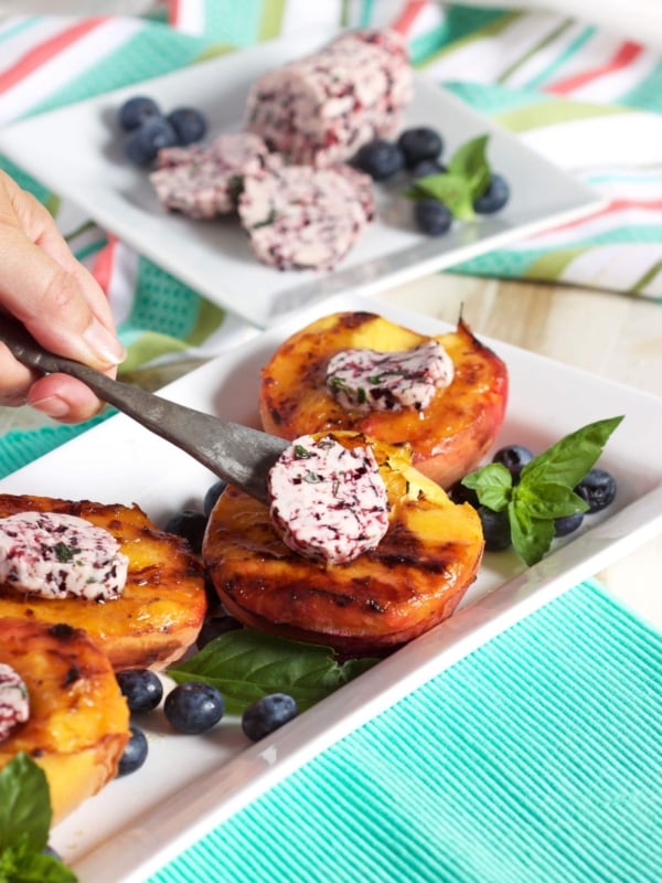 A quick and easy Grilled Peach recipe topped with an easy to make blueberry basil butter from TheSuburbanSoapbox.com.