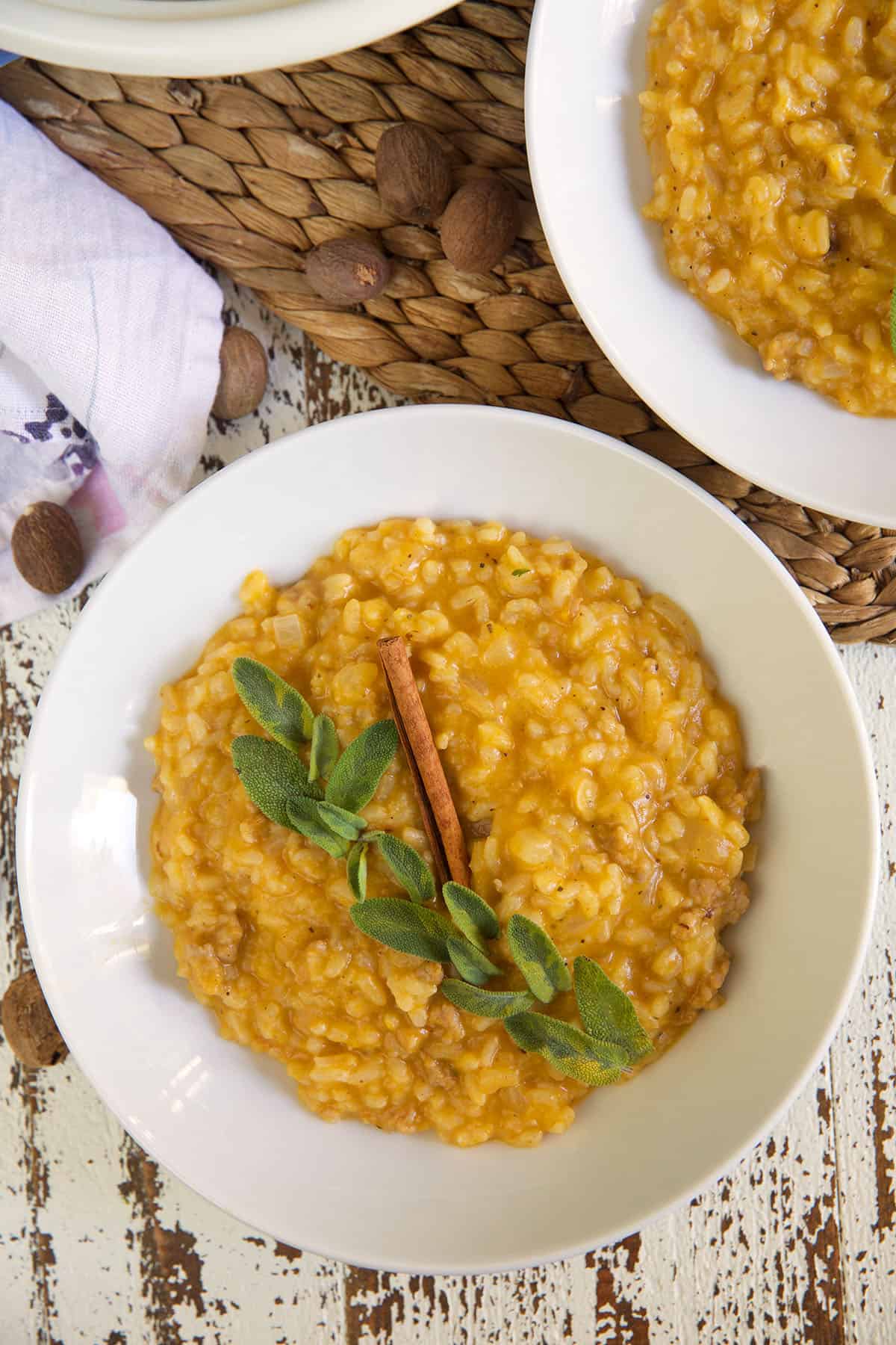 A white bowl is filled with butternut squash risotto.