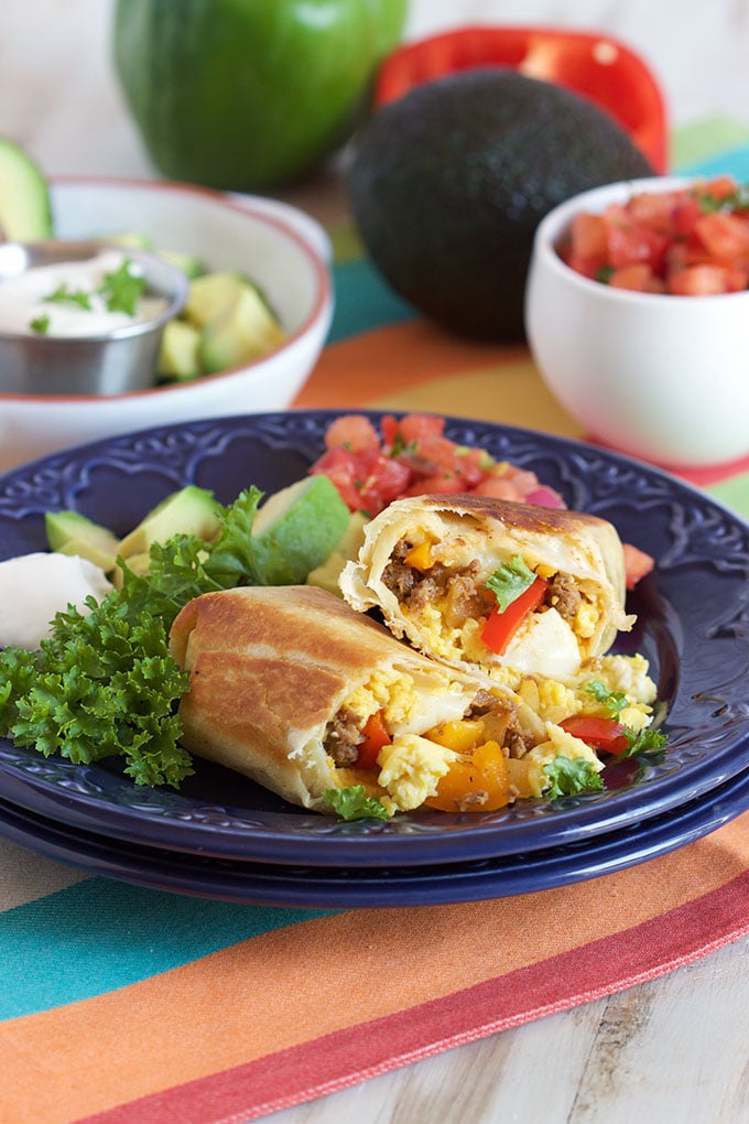 Breakfast Burrito on a blue plate with parsley and avocado.