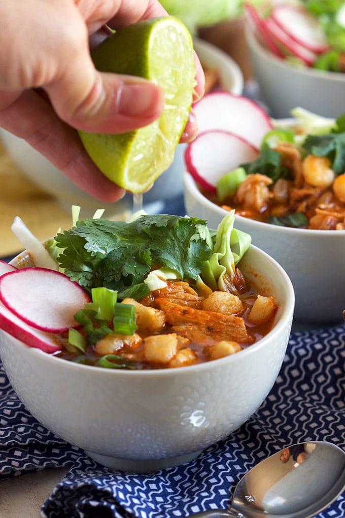 Super easy to make Pork Posole recipe is the BEST, most flavorful stew ever! TheSuburbanSoapbox.com