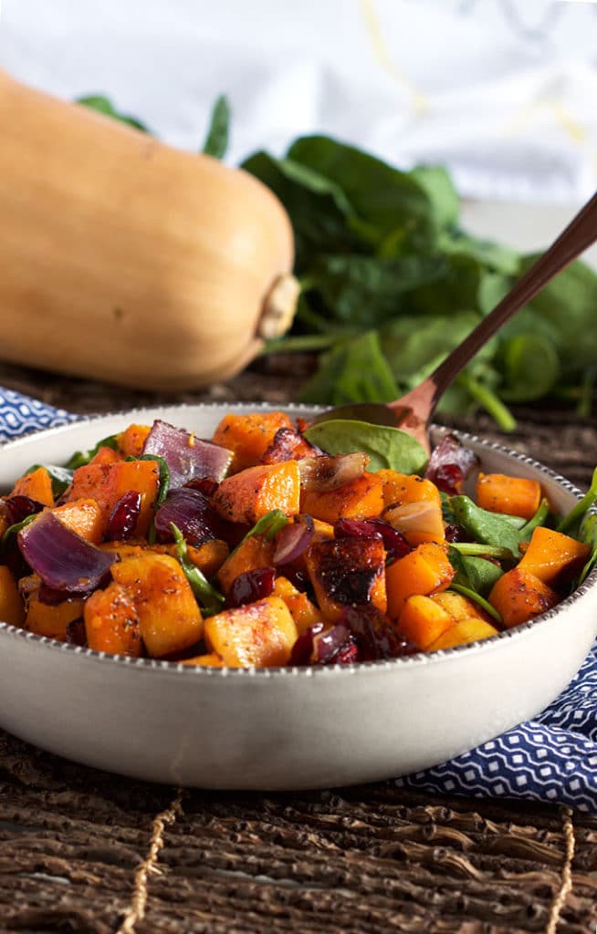 This easy Roasted Butternut Squash with Spinach and Cranberries is the most amazing vegetarian side dish ever. TheSuburbanSoapbox.com