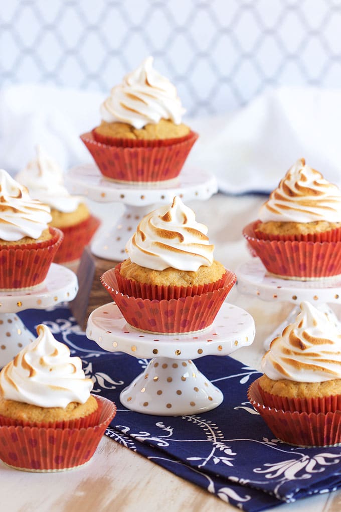 Sweet potato cupcakes on a white and gold cupcake stand with swirly toasted marshmallow meringue frosting.