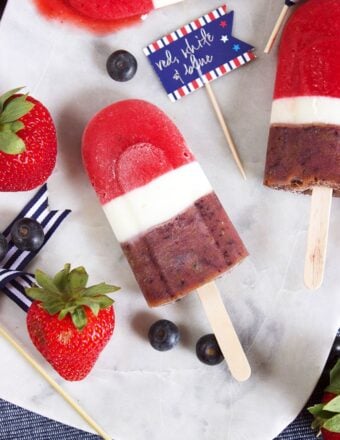 Super easy, healthy and sweet, the perfect dessert for summer. Red White and Blueberry Smoothie Popsicles are a hit with friends, families and guests of all ages! | TheSuburbanSoapbox.com