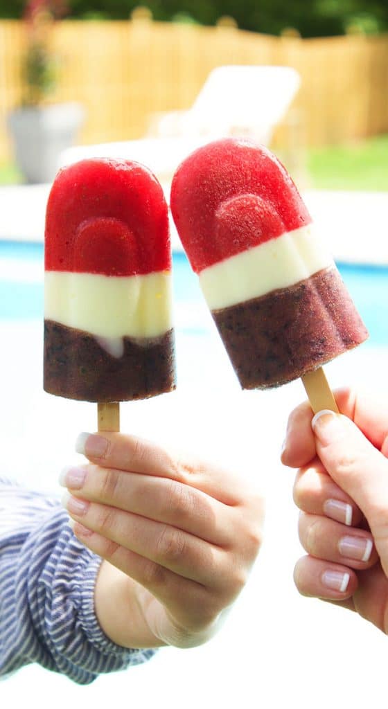 Super easy, healthy and sweet, the perfect dessert for summer. Red White and Blueberry Smoothie Popsicles are a hit with friends, families and guests of all ages! | TheSuburbanSoapbox.com